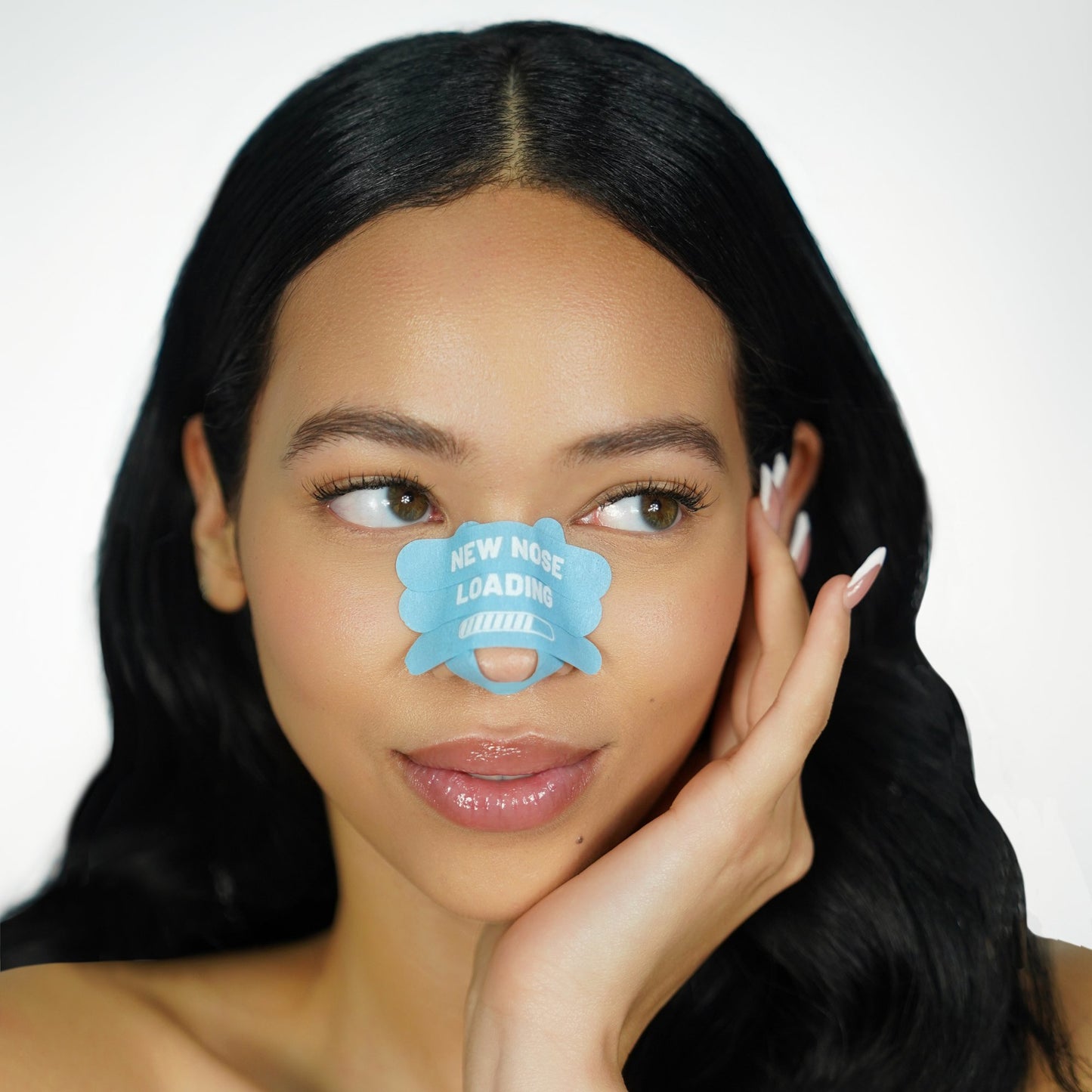 Woman with blue 'recovery babe' pre-cut rhinoplasty nose strips on her nose against a white background